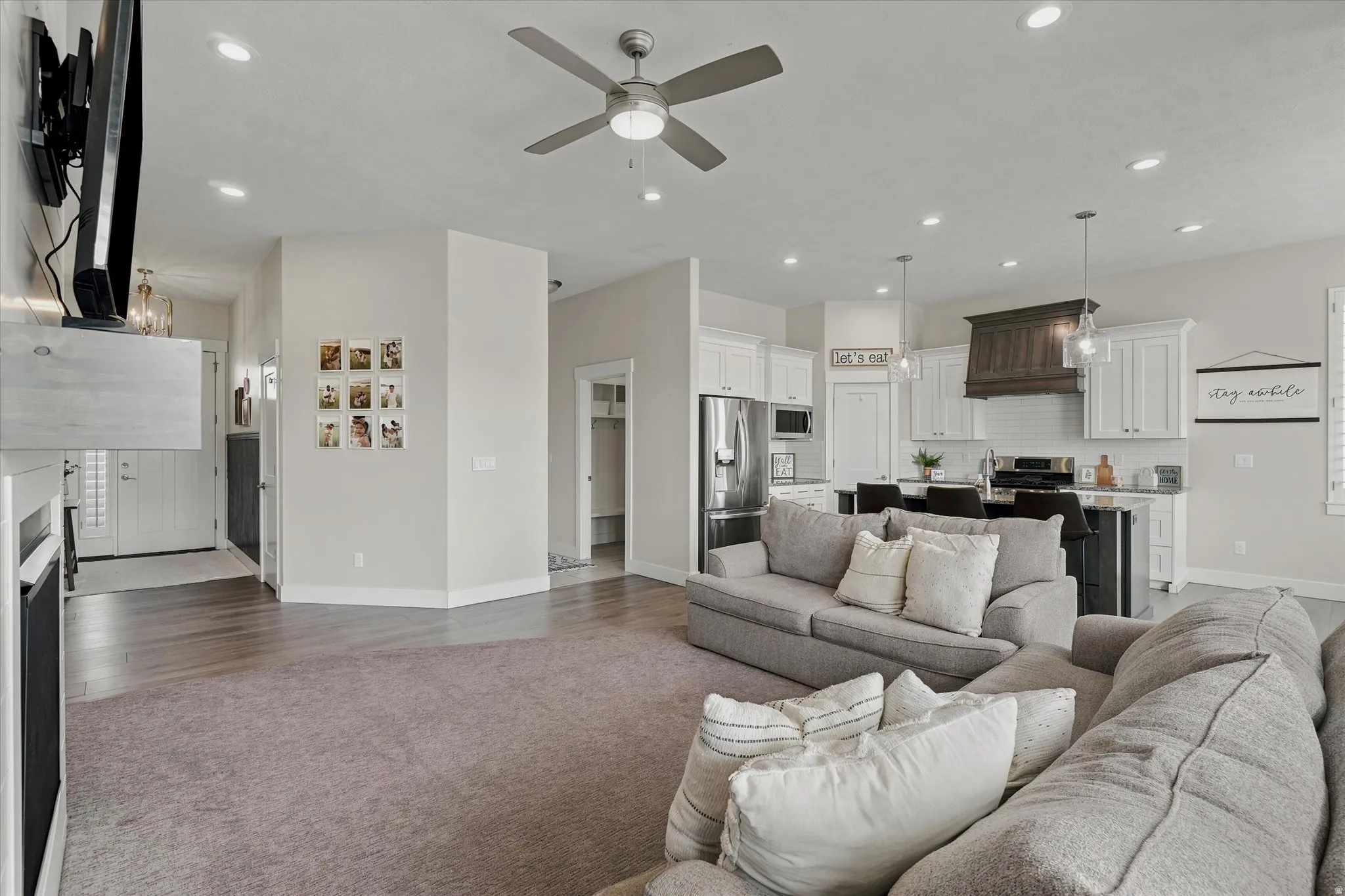 Open-concept living space featuring recessed lighting and a ceiling fan