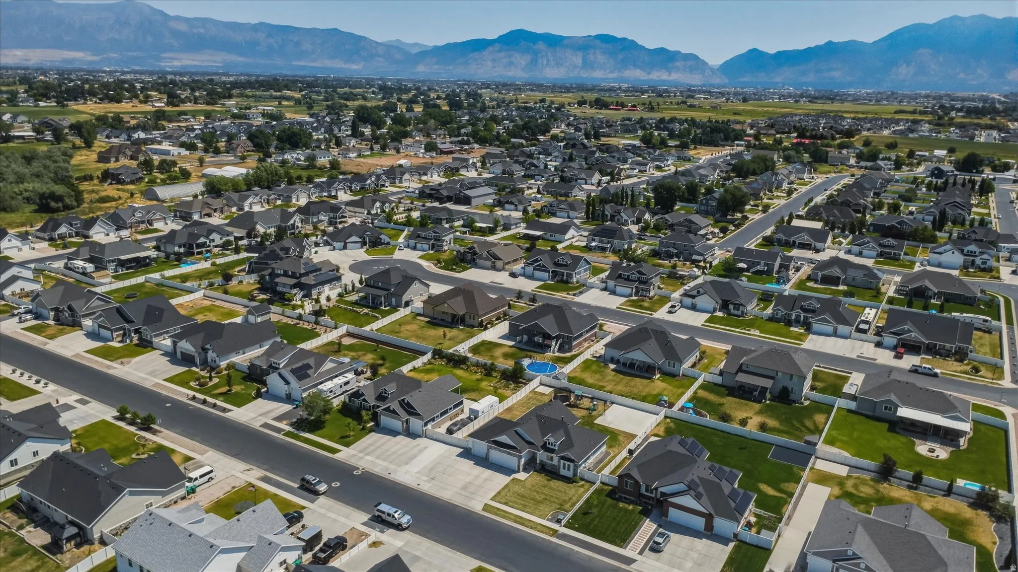 Aerial perspective showcasing a residential neighborhood with a mountain backdrop