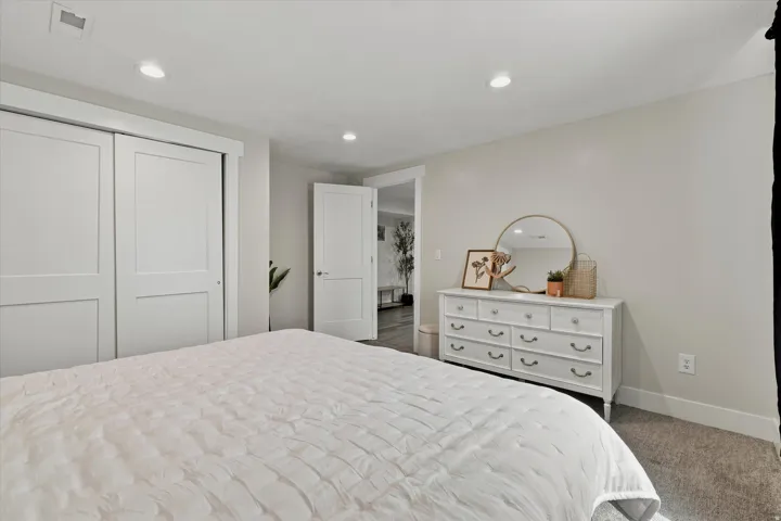Bedroom featuring light gray walls, recessed lighting, and gray carpet flooring
