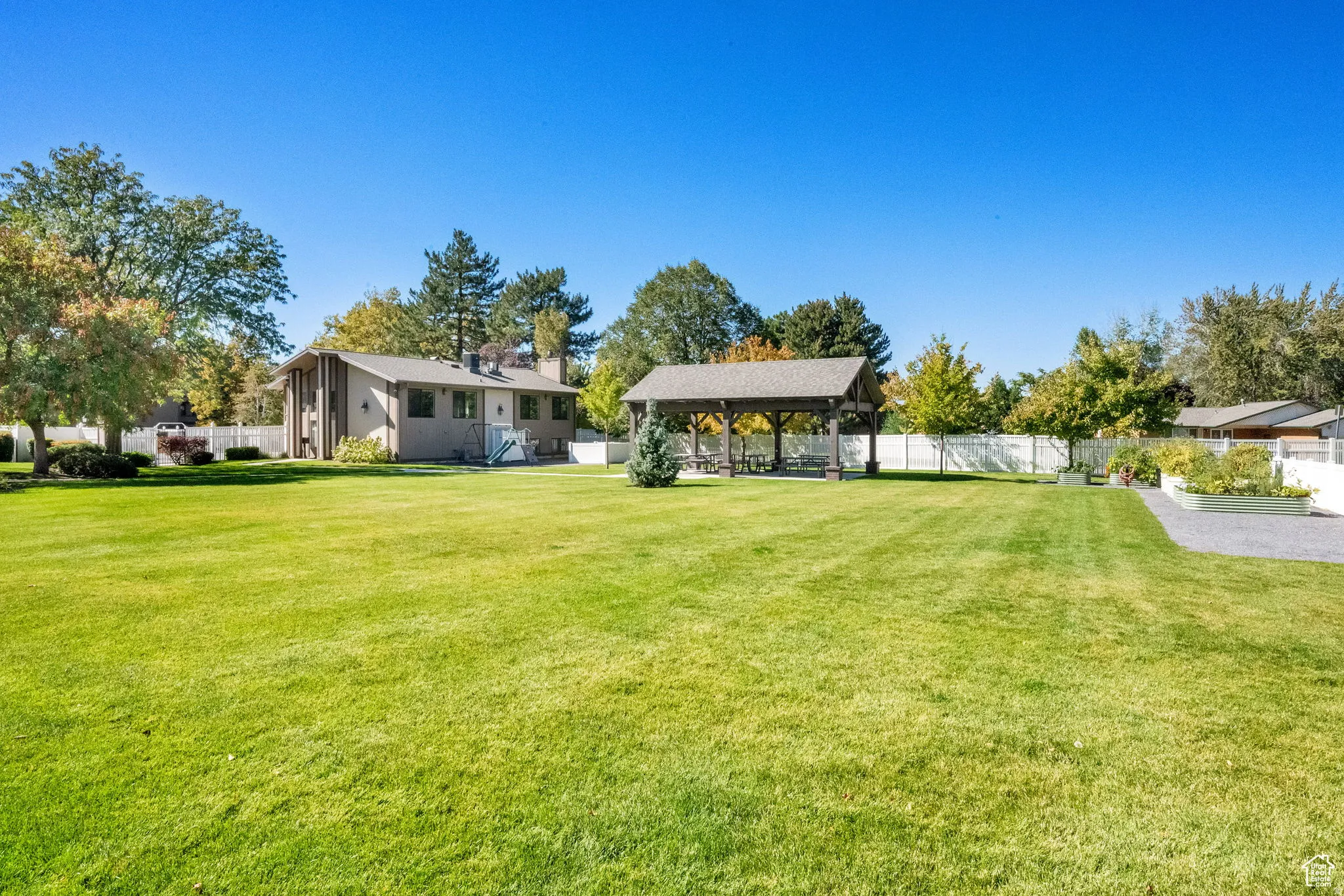 Clubhouse and park with community gardens, separate dog park, and covered picnic pavilion
