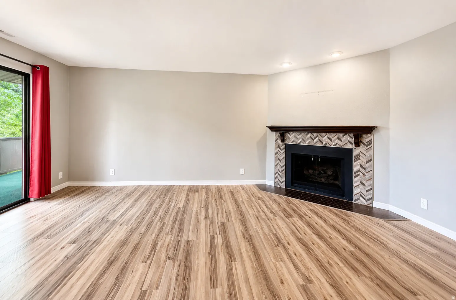 Spacious main living area with fireplace and balcony access