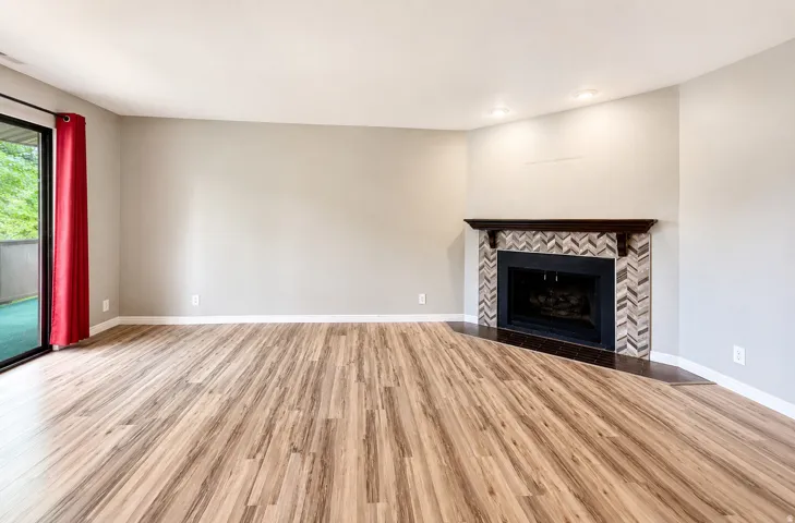Spacious main living area with fireplace and balcony access