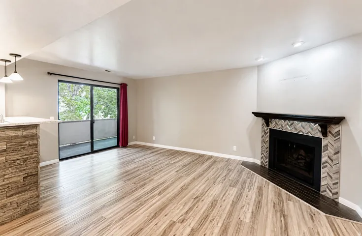 Spacious main living area with fireplace and balcony access