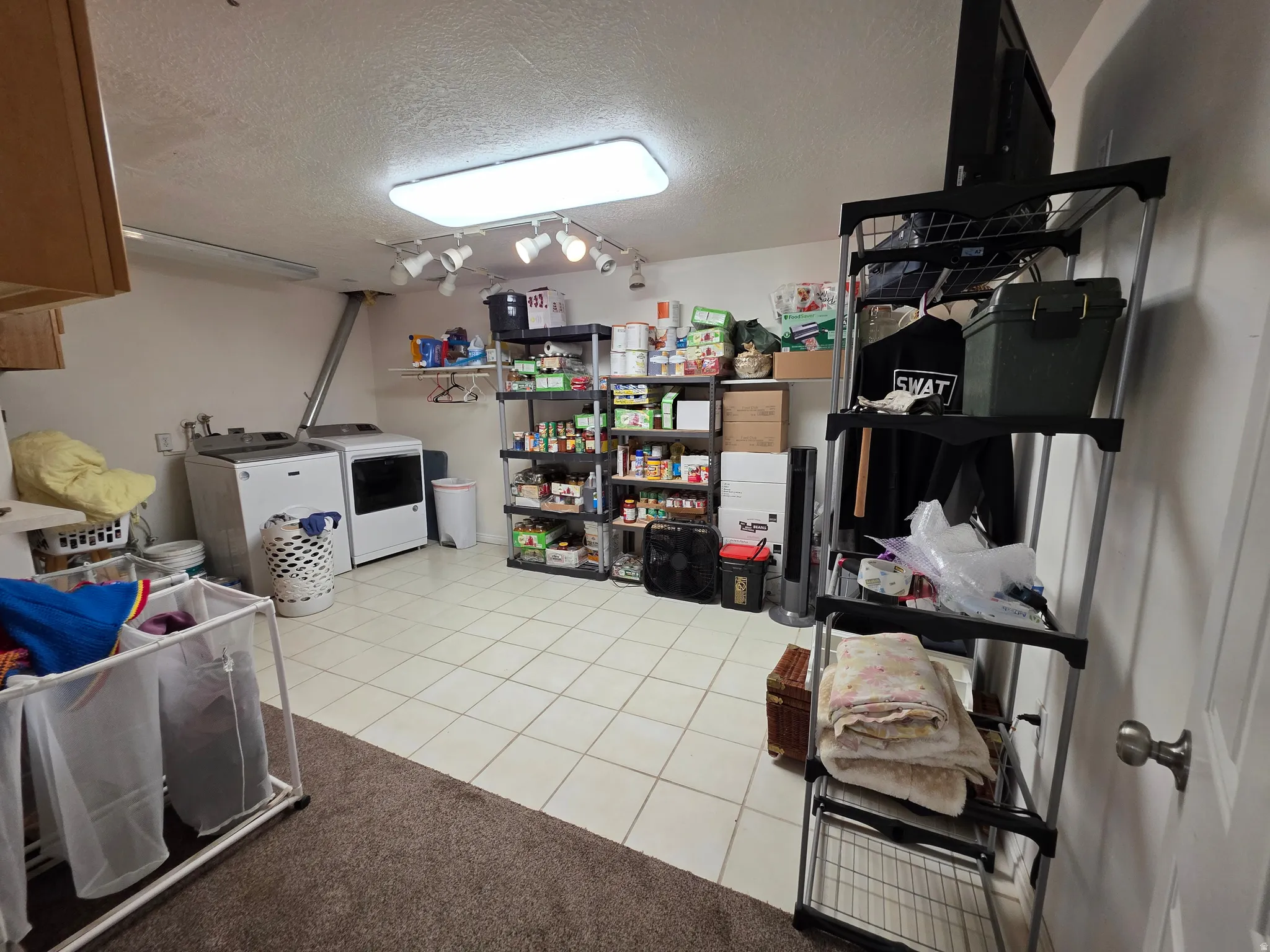 Beautician Sink, Utility room featuring white tile flooring, built-in cabinetry, overhead fluorescent lighting, and track lighting