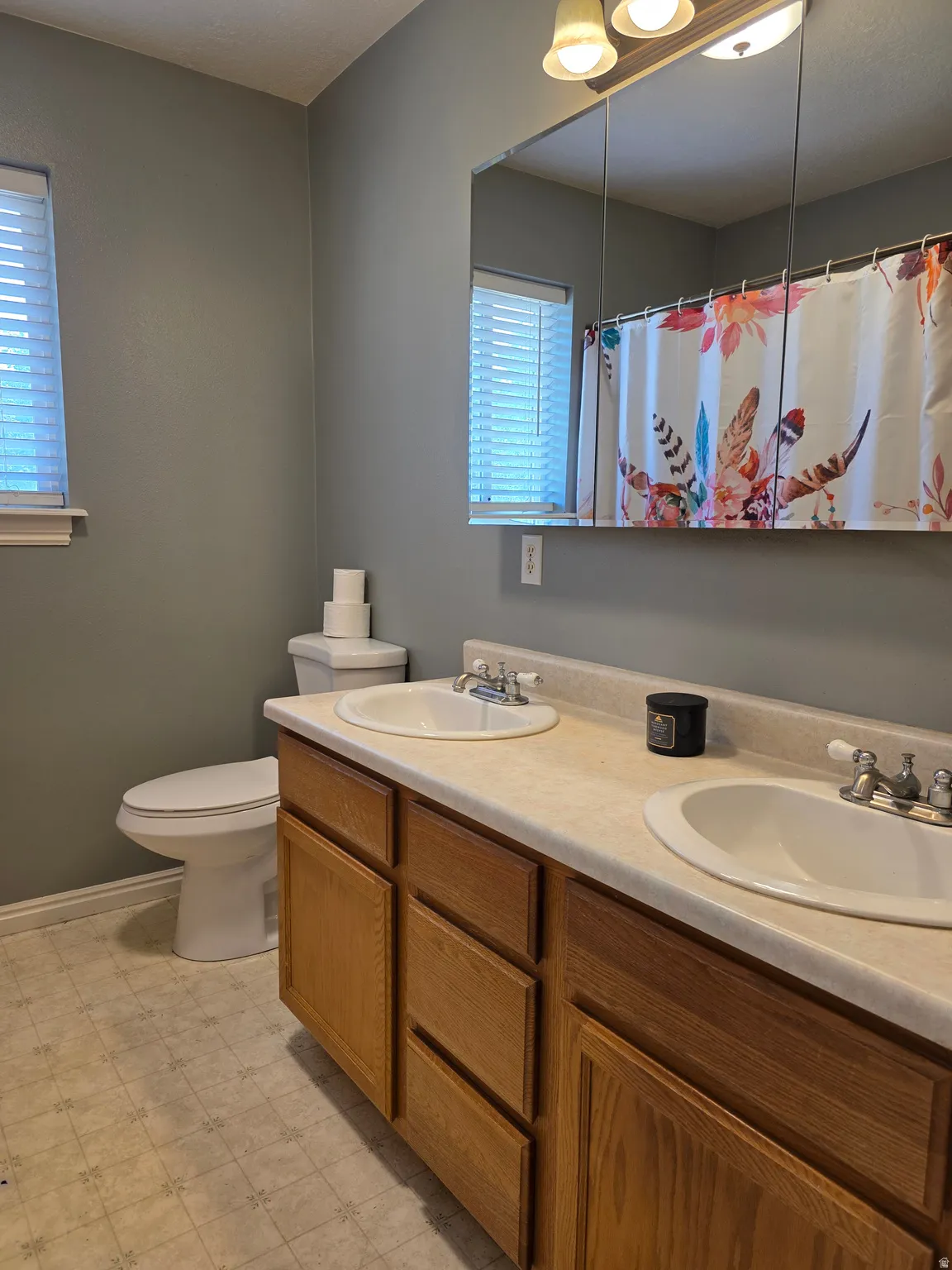 Dual vanity with wood-finish cabinetry and integrated sinks
