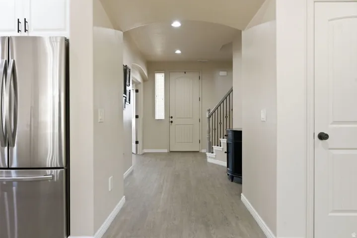 Bright entryway featuring light wood-finish flooring, recessed lighting, and a neutral color palette