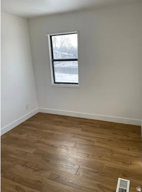 Neutral-toned walls complement wood-finish flooring