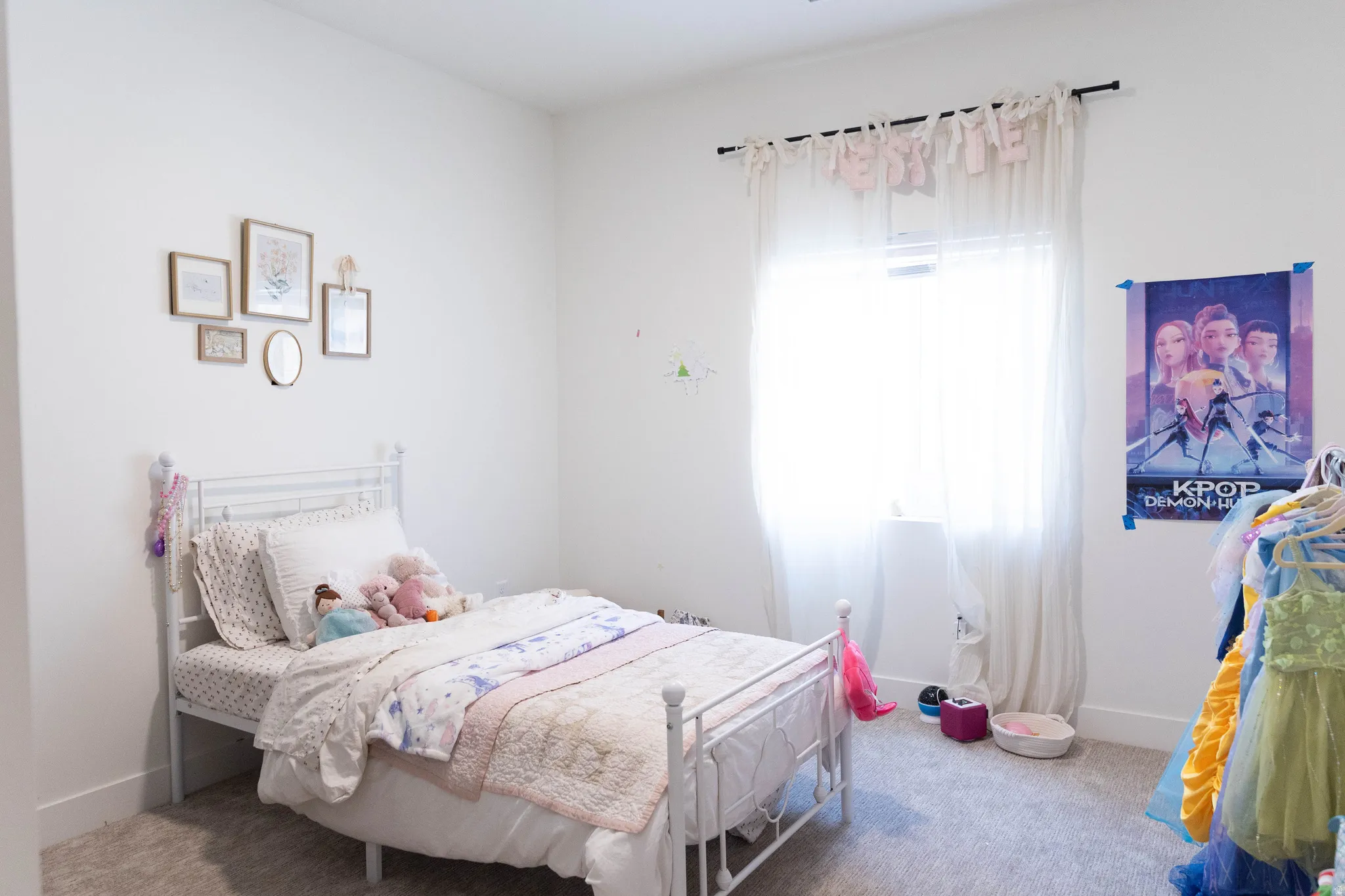 Room featuring neutral wall paint, light-colored carpet flooring, and a single window with sheer curtains