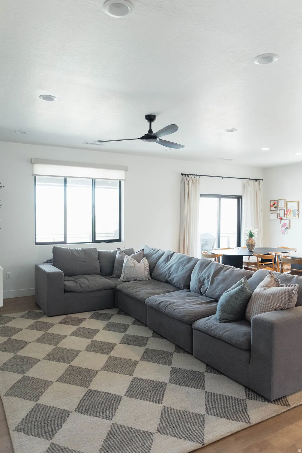 Open-concept living area with light wood-finish flooring