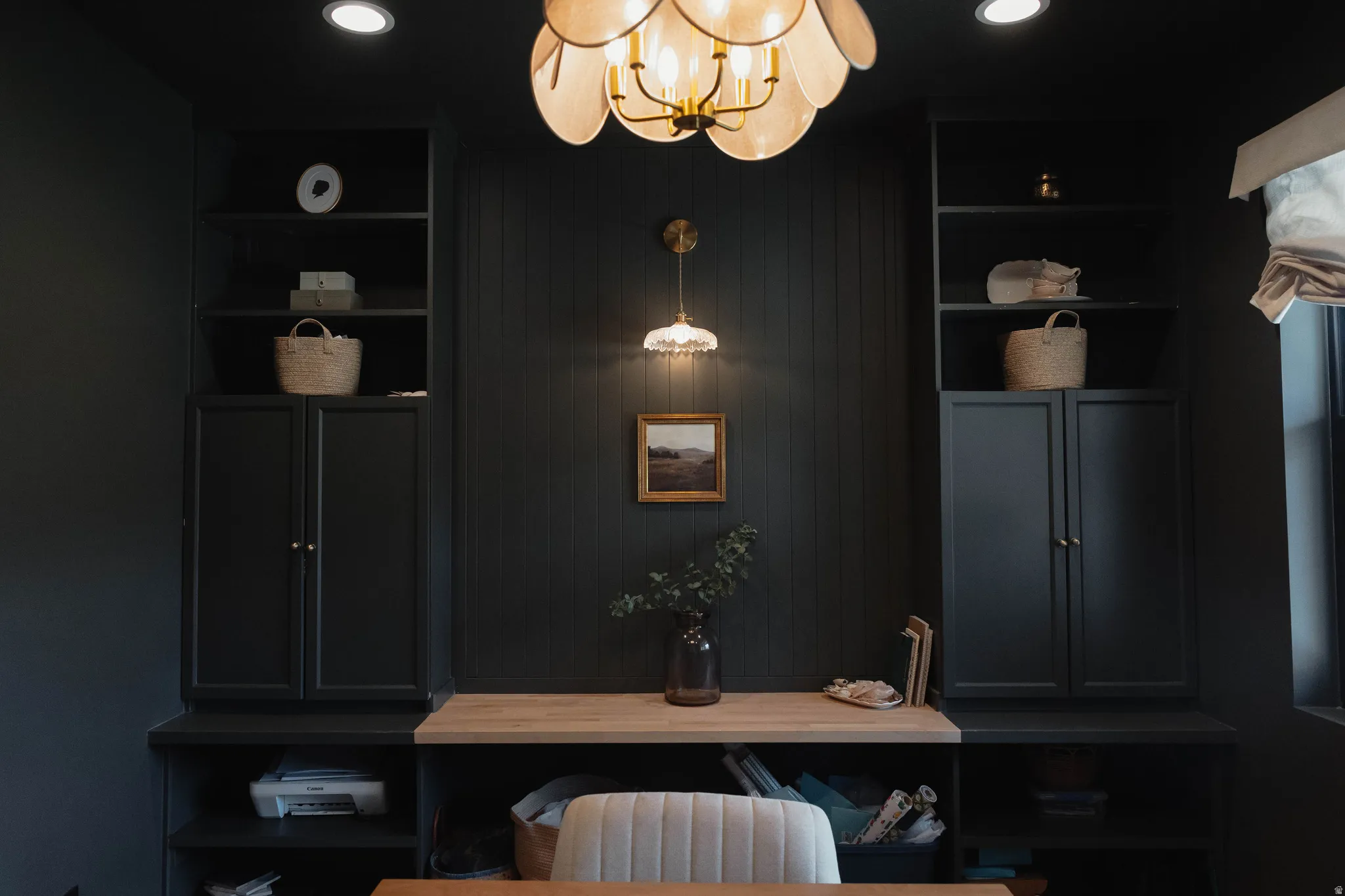 Built-in cabinetry in a dark finish with open shelving, complemented by a light wood-finish countertop