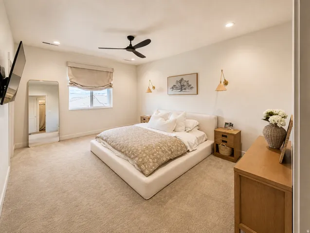 Plush carpet flooring, recessed lighting, ceiling fan, and window with a roller shade