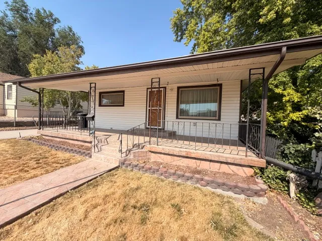 Covered front porch featuring decorative metal railings and support columns