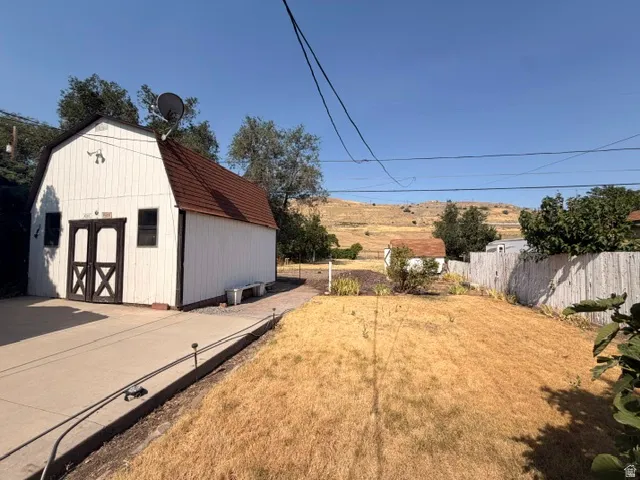Detached barn-style outbuilding with a gambrel roof and double entry doors