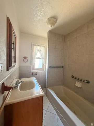 Bathroom featuring a vanity with a light-toned countertop, a built-in sink, and a chrome faucet