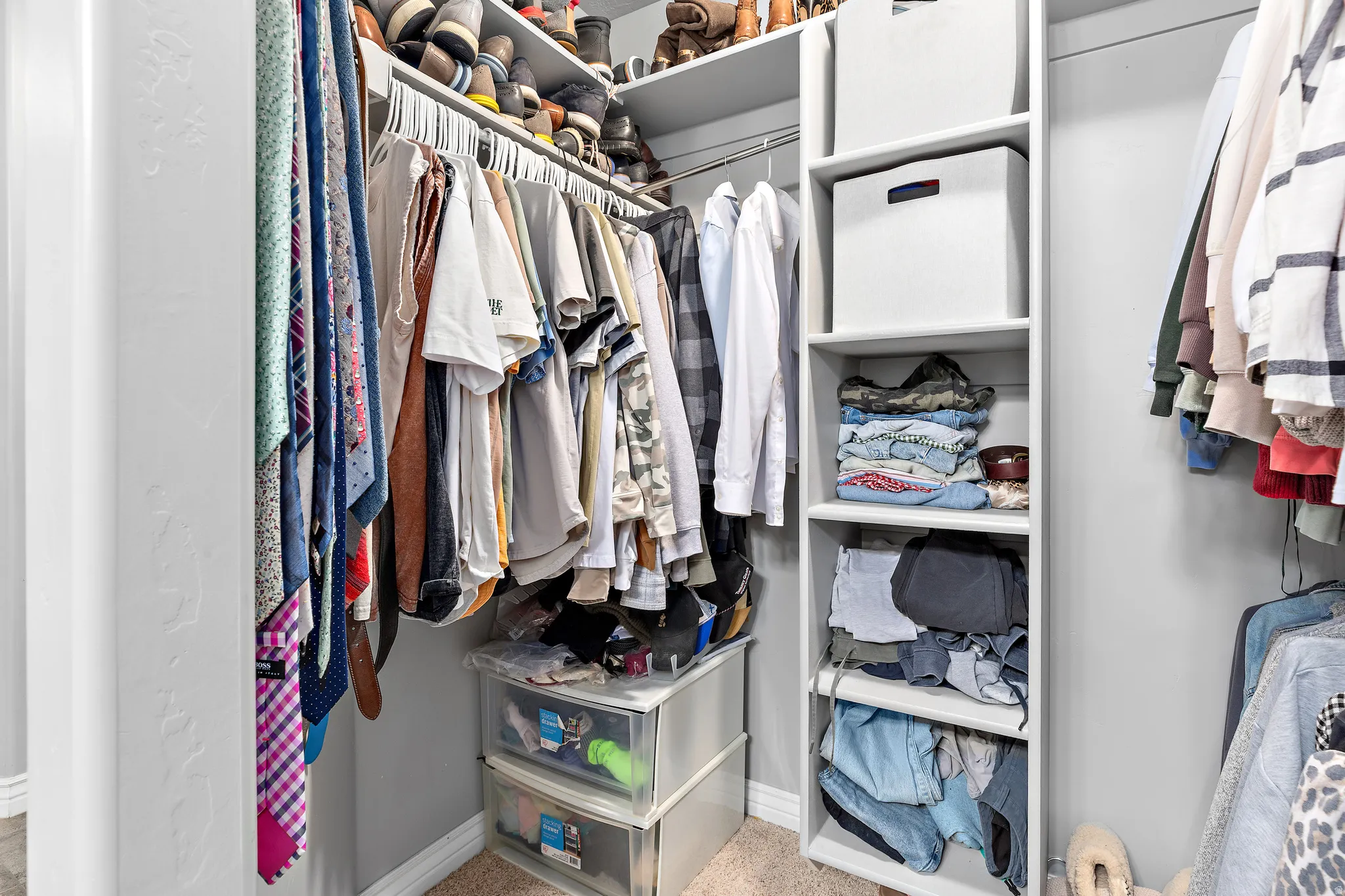 Built-in closet system featuring multiple hanging rods, integrated shelving, and upper storage compartments