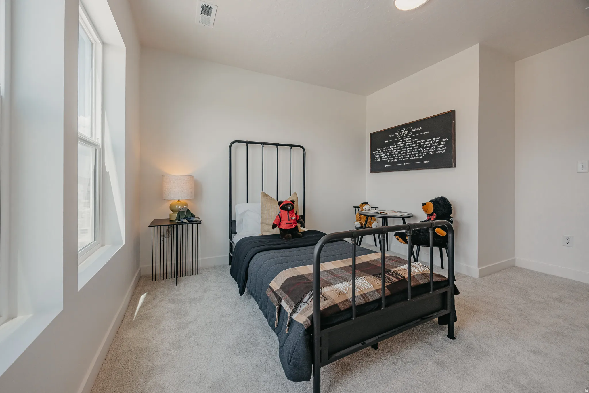 Carpeted flooring, vaulted ceiling, recessed lighting, and a large window