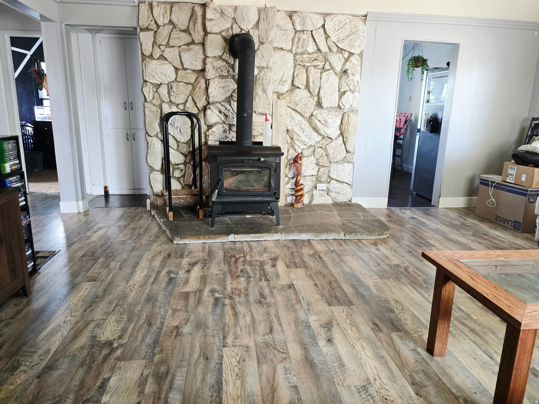 Stone-clad wood-burning stove with a raised hearth