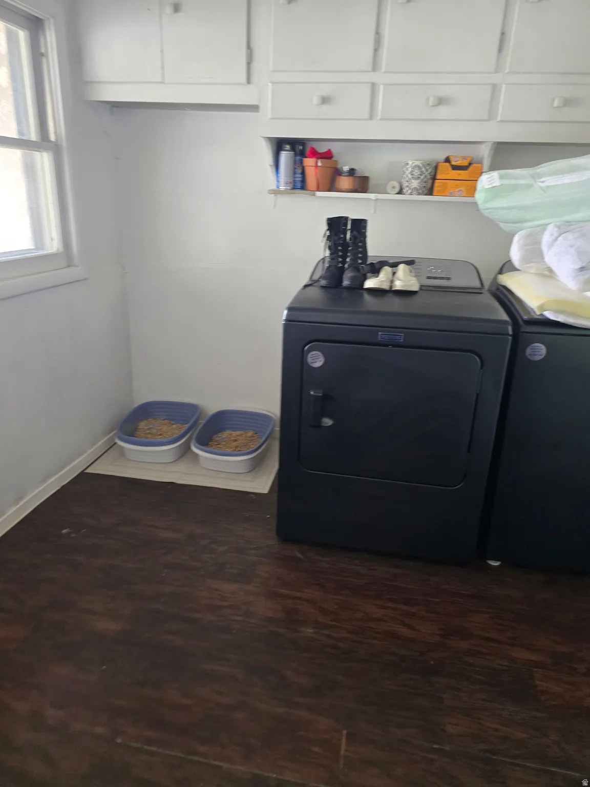 Utility room featuring wood-finish flooring