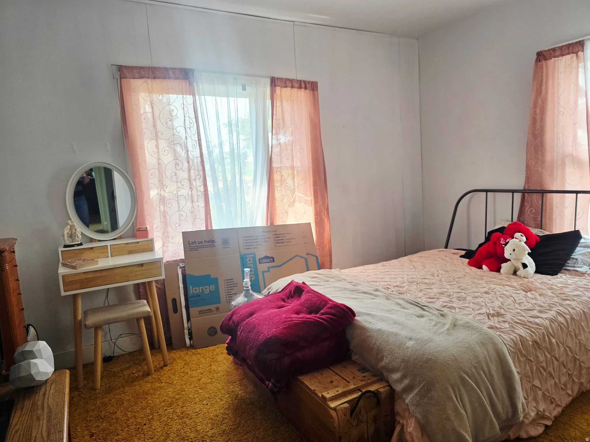 Room featuring light-colored vertical paneling, a large window, and textured carpeting