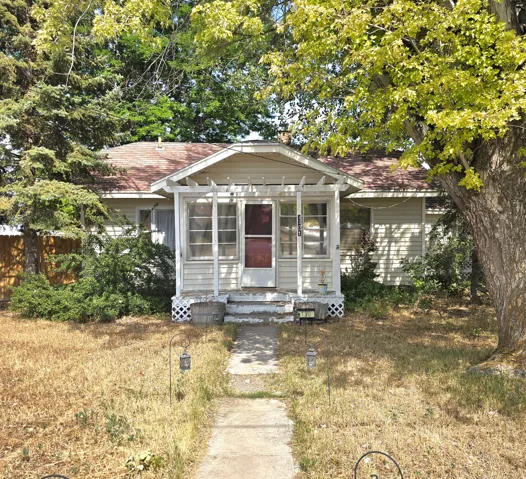Charming single-story residence featuring a covered front porch with lattice detailing