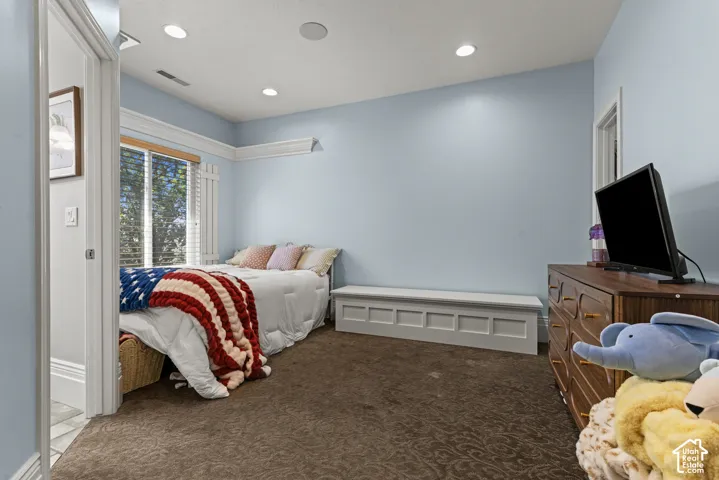 Room featuring light blue walls and brown patterned carpeting