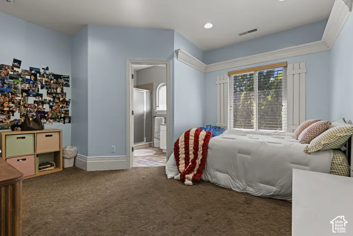 Bedroom featuring light blue walls, brown carpet, recessed lighting, and white crown molding