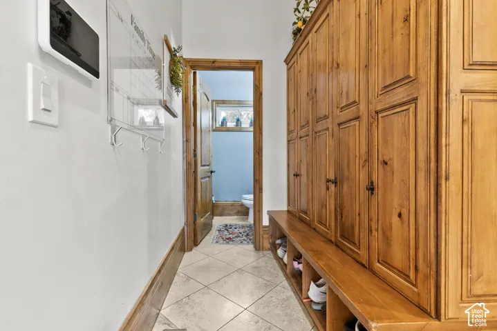 Custom wood built-in cabinetry with paneled doors and storage bench