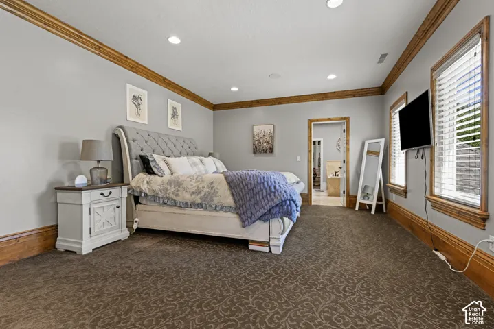 Spacious room featuring patterned carpet flooring, recessed lighting, and wood-finish trim work