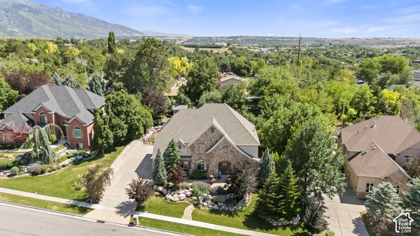 Contemporary residence featuring a prominent gabled roofline and a stone and stucco exterior