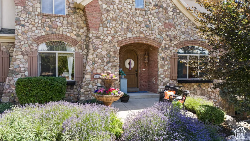 Stone and brick exterior featuring arched entryways and windows