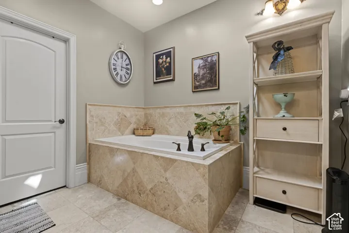 Soaking tub with bronze fixtures set in a tiled surround