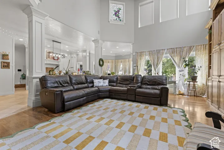 Living area featuring soaring ceilings and an arched window with stained glass detail