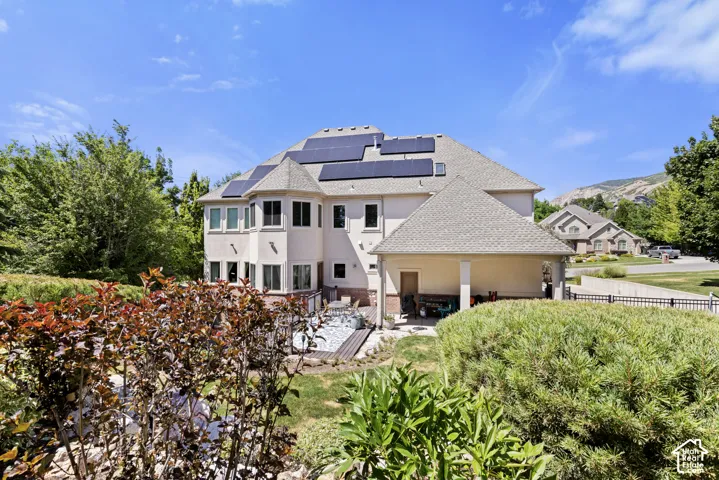 Two-story property featuring stucco siding and a multi-level roofline