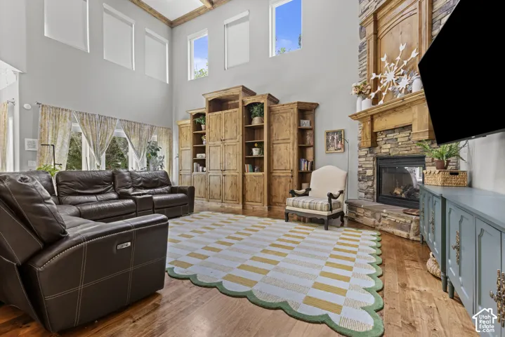 Double-height ceiling featuring wood beam accents and upper transom windows