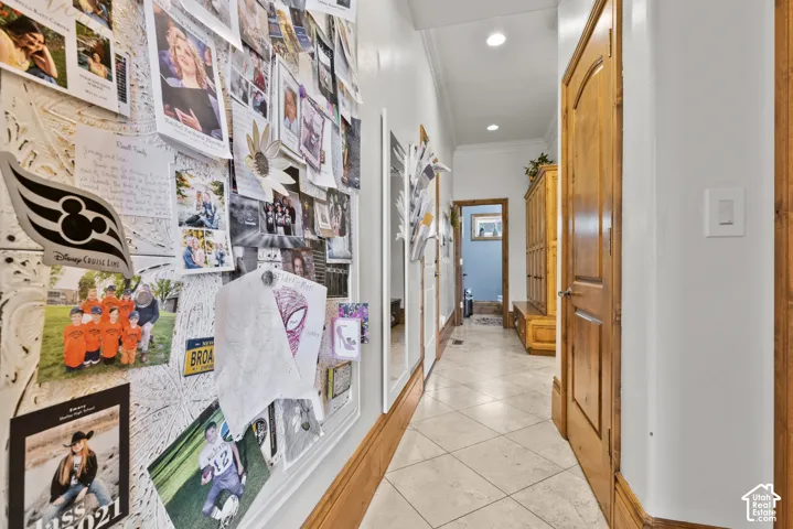 Hallway featuring light-toned tile flooring, recessed lighting, and solid wood interior doors with matching trim