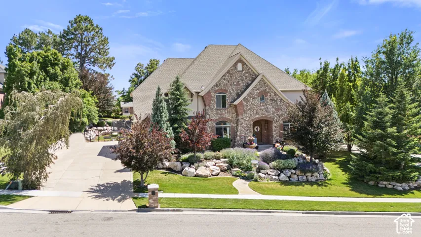 Stone and stucco exterior with multiple gables and a prominent front entrance