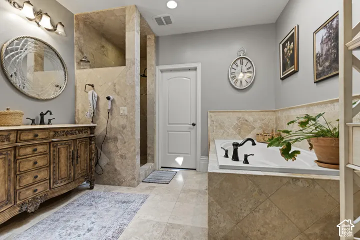Bathroom featuring a built-in tub with dark fixtures, a tiled surround, and light gray wall paint