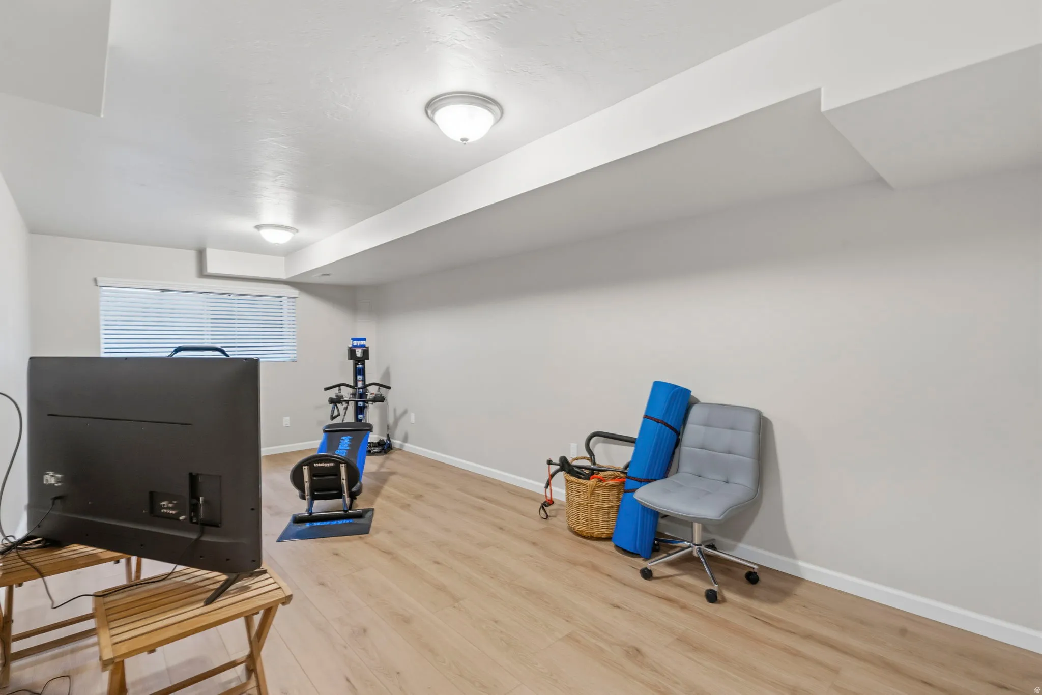 Bedroom/Exercise room featuring LVP flooring, two-tone paint, two-door closet and extra inside shelving, lots of natural light