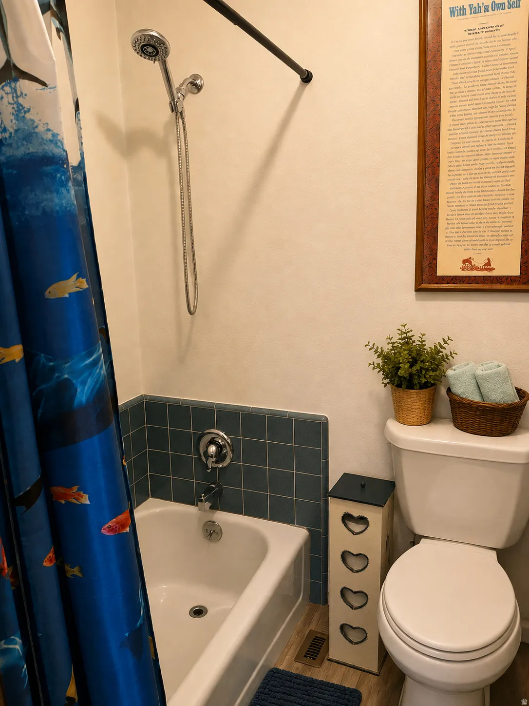 White bathtub with blue tile surround and chrome fixtures