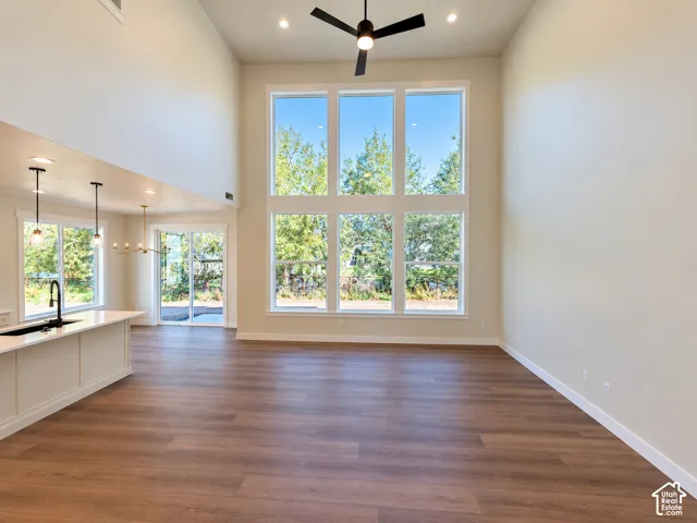 Vaulted ceilings, wood-finish flooring, and large windows with integrated transom panels