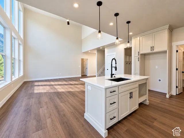 Vaulted ceiling with recessed lighting and expansive windows