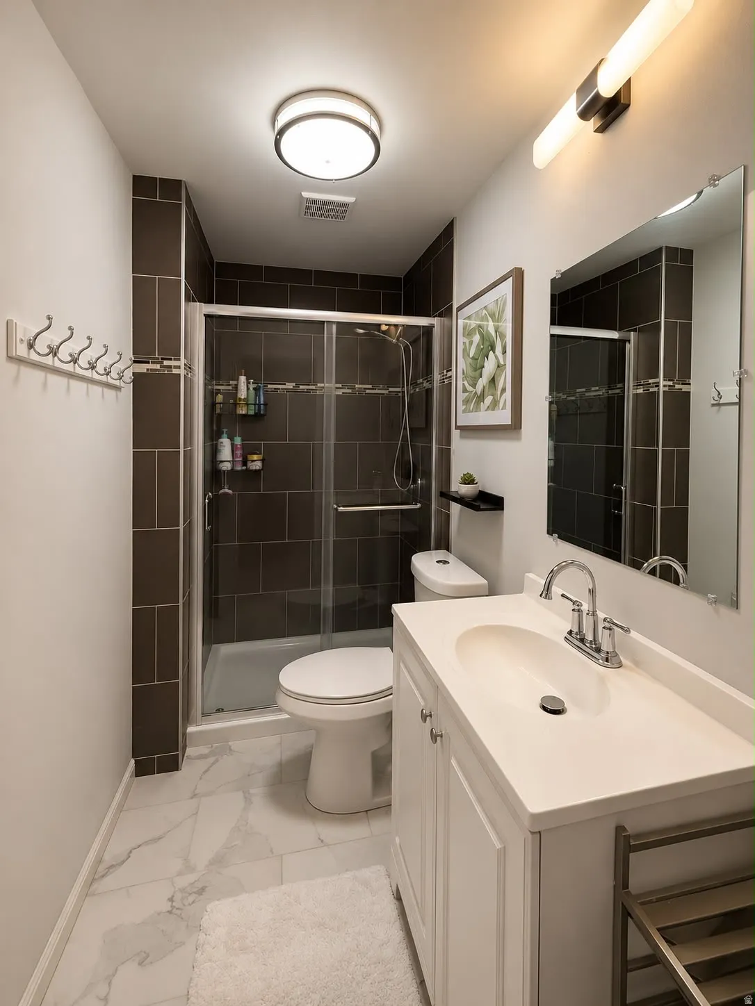 Bathroom featuring a white vanity with integrated sink, chrome faucet, and rectangular mirror