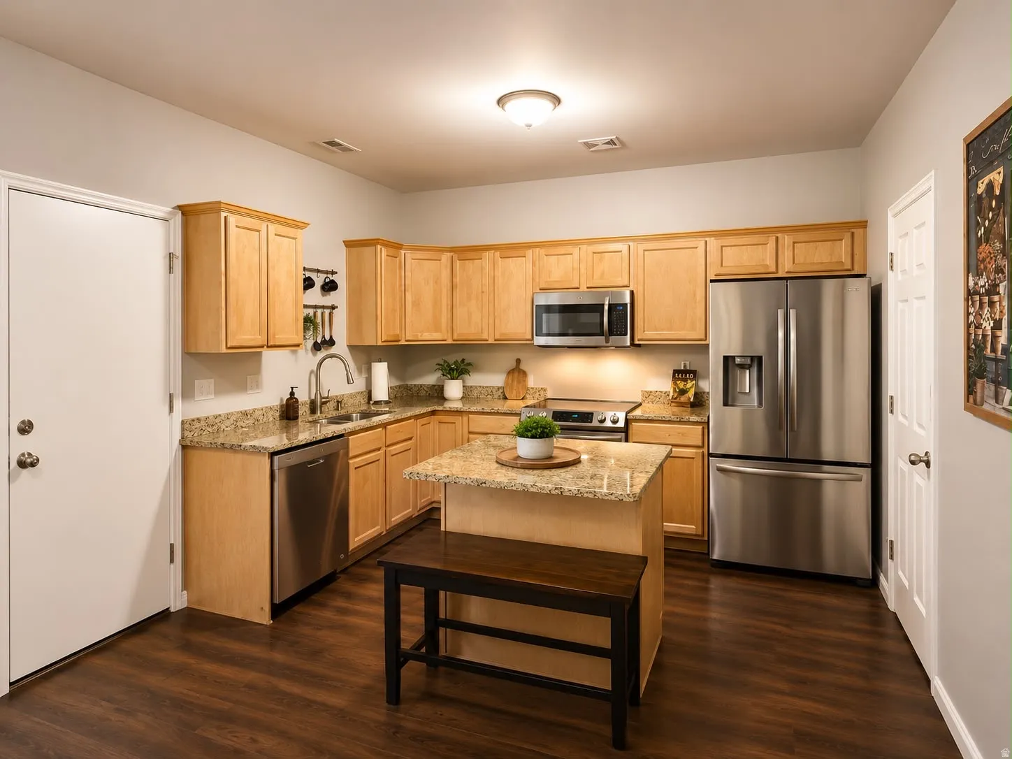 Kitchen featuring wood-finish cabinetry, granite countertops, stainless steel appliances, and a central island
