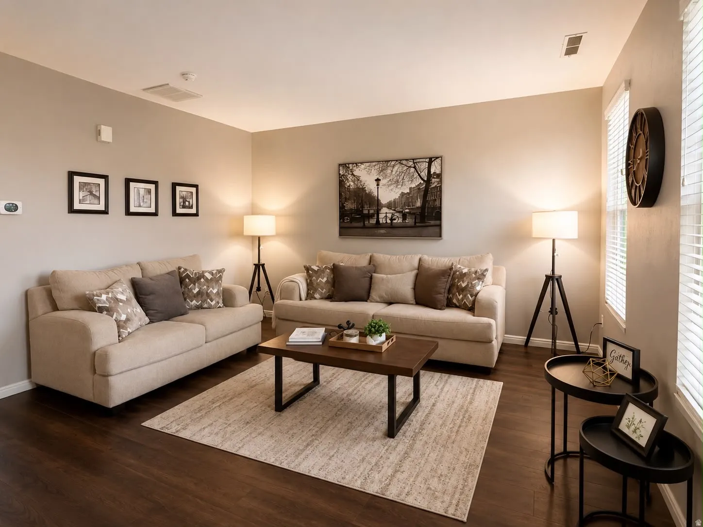 Spacious living area featuring neutral wall tones, wood-finish flooring, and recessed lighting