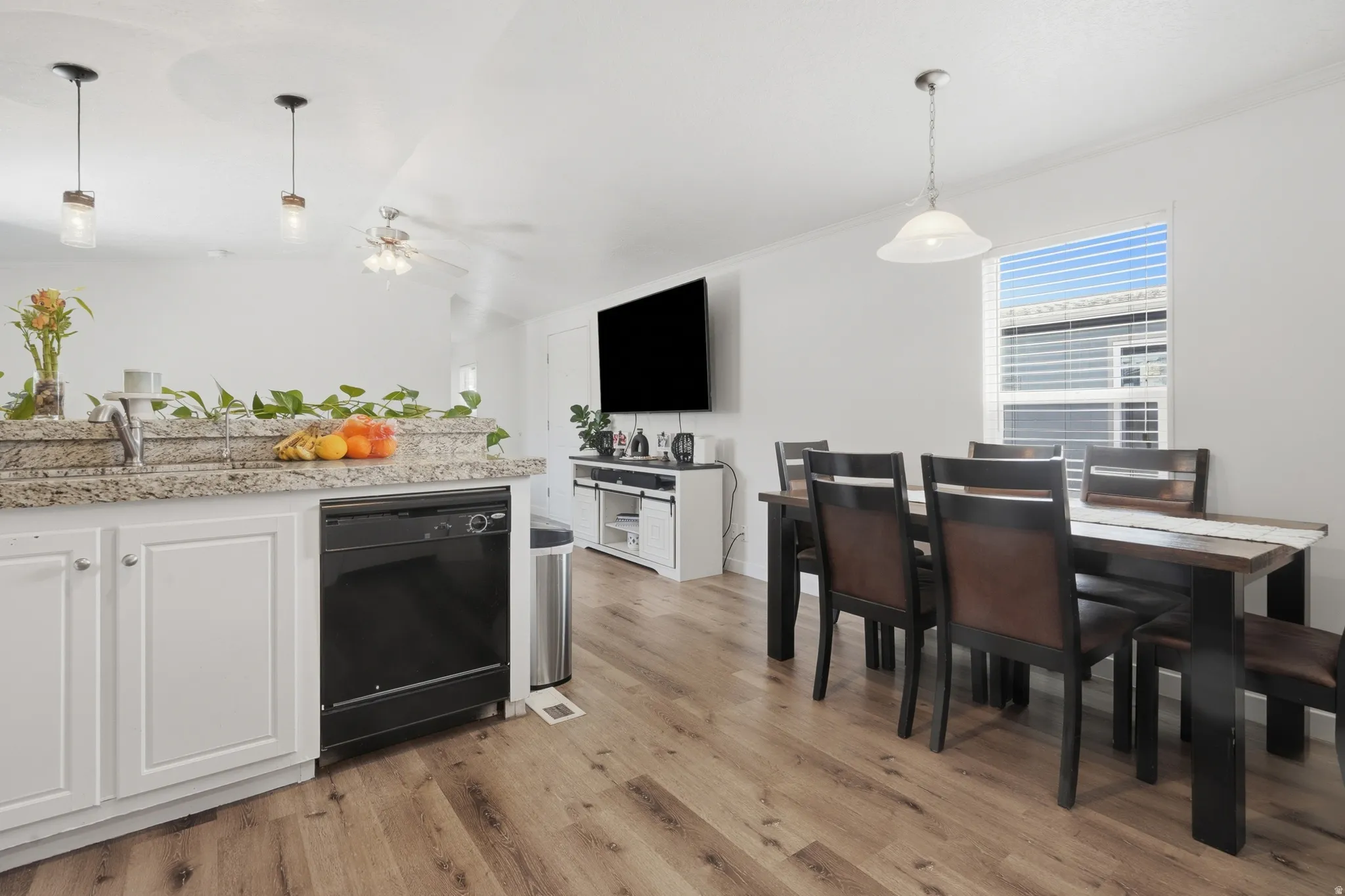 Kitchen and dining area featuring wood-finish flooring
