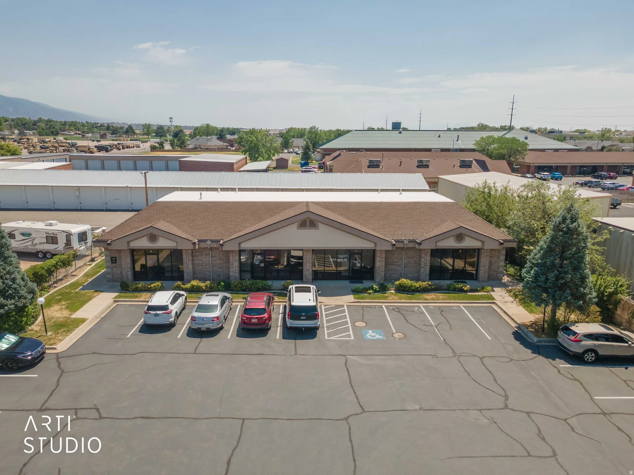 Commercial building featuring a gabled roof and stone facade accents