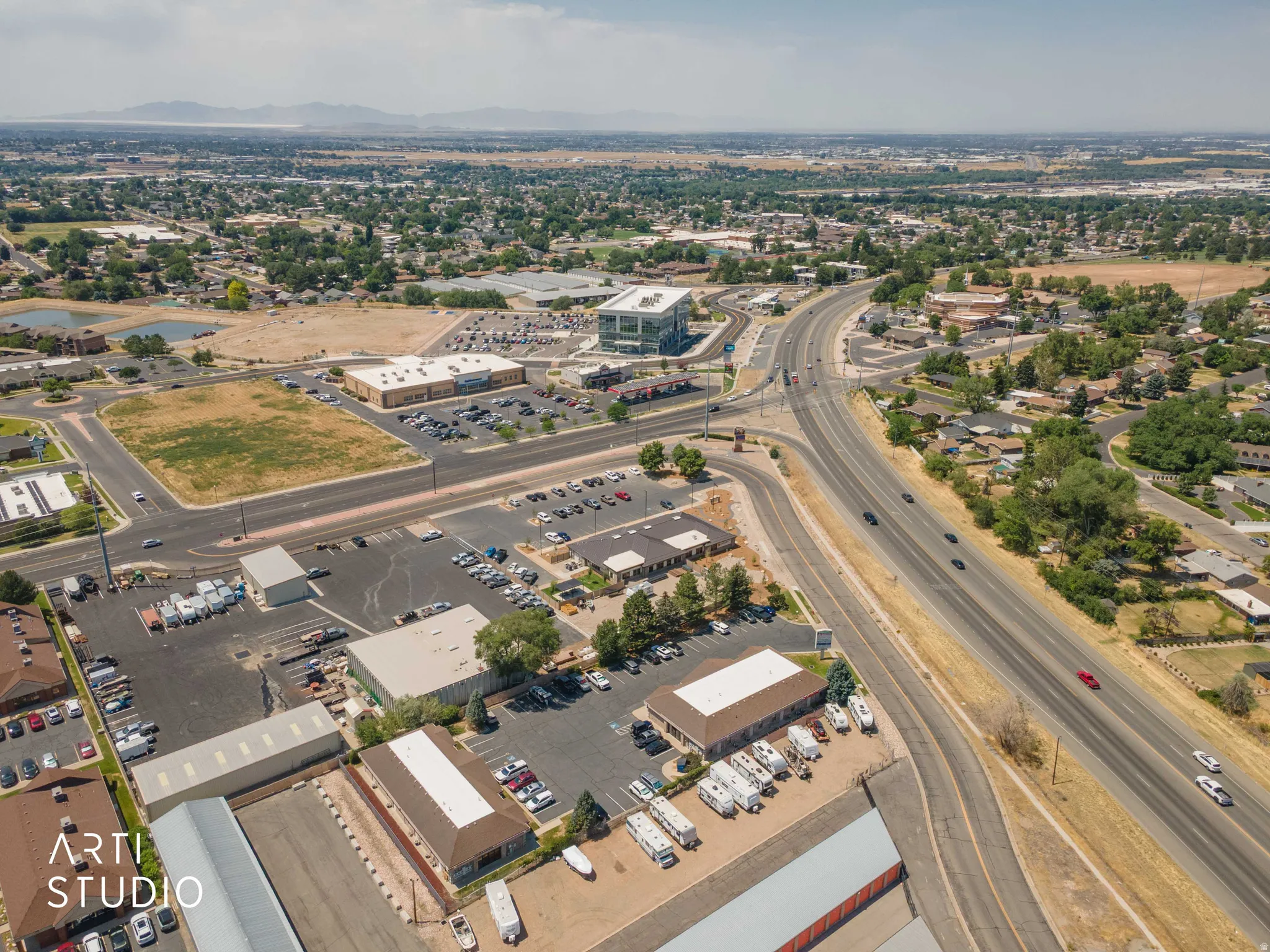 Aerial perspective showcasing a mixed-use commercial and residential district with prominent roadways