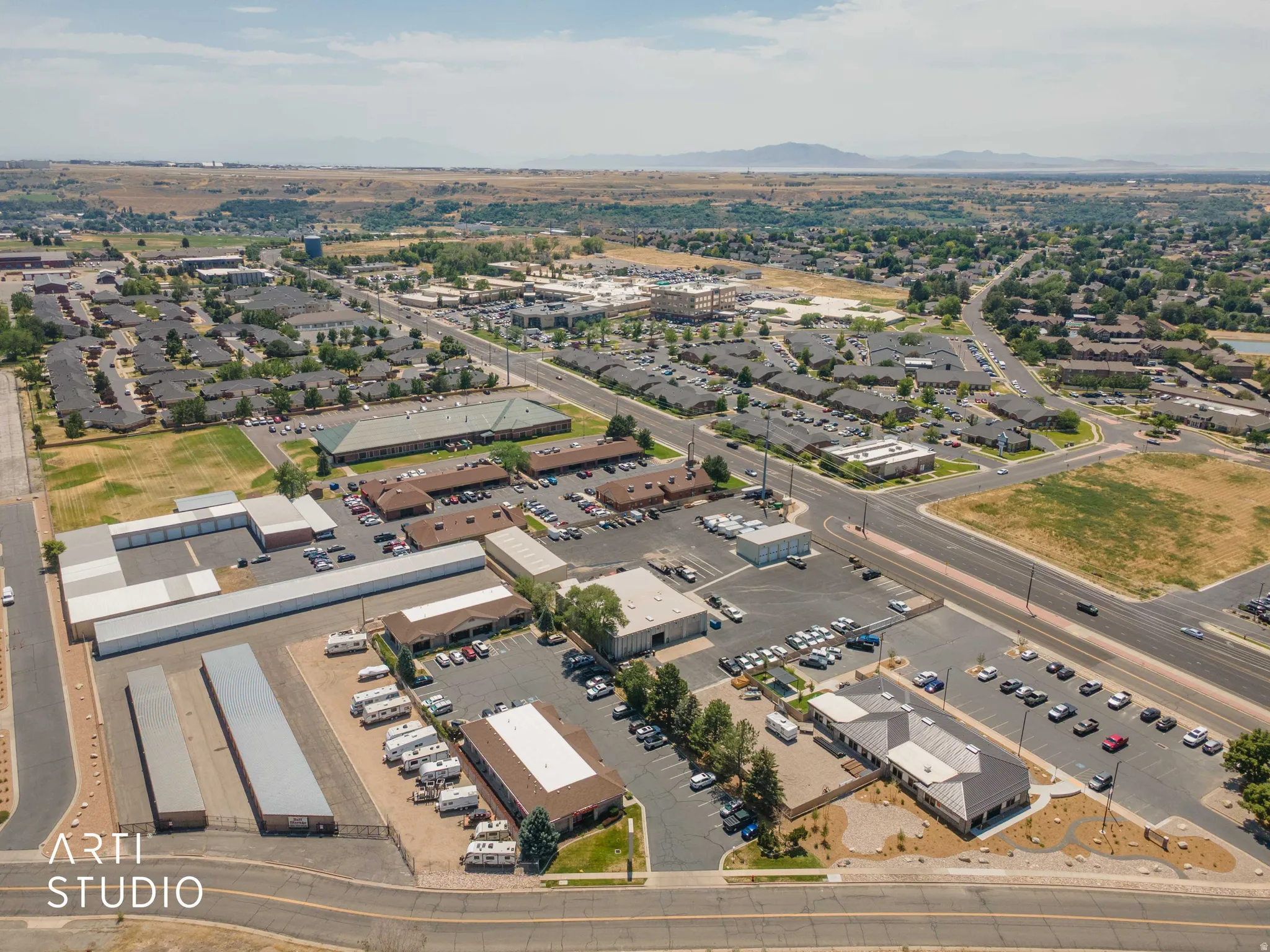 Expansive commercial property featuring multiple buildings, surface parking, and a variety of commercial structures