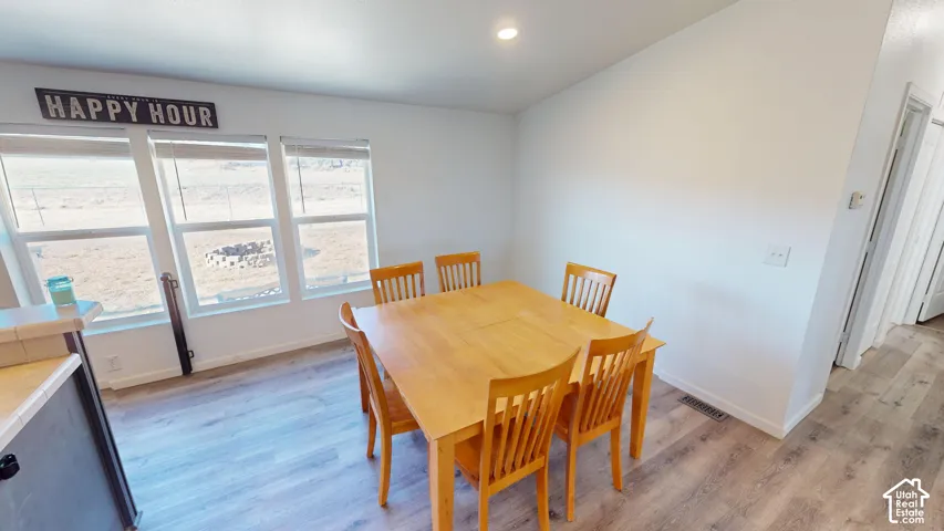 Bright dining area with three large windows
