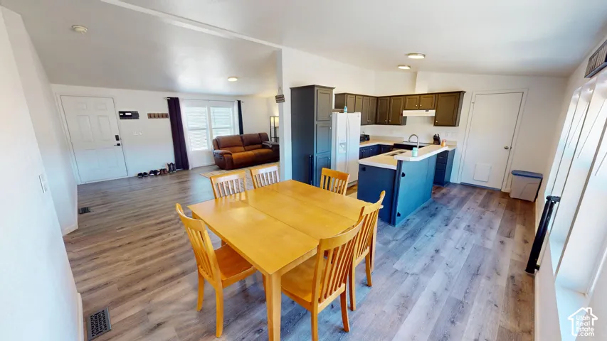 Open-concept living space featuring wood-finish flooring throughout